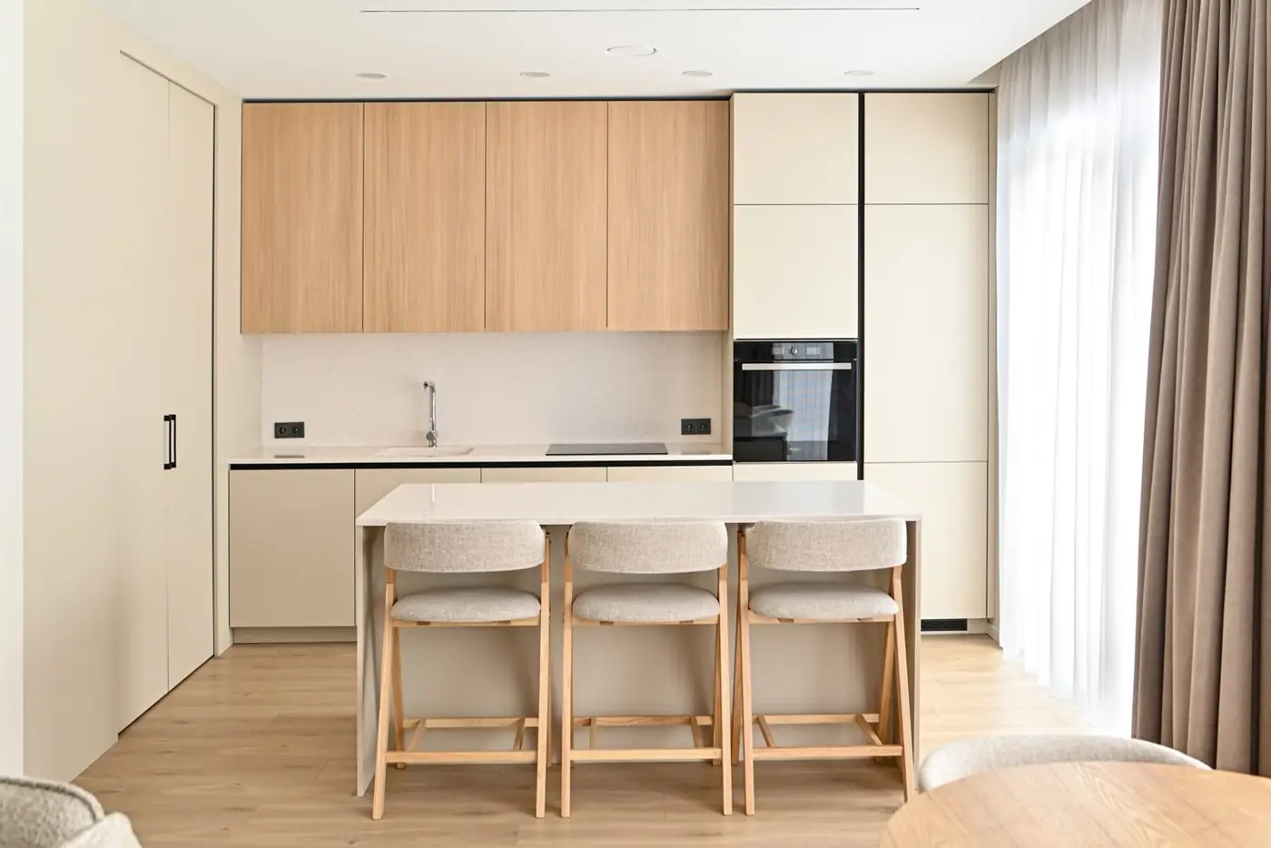 Light custom kitchen with oak upper cabinets