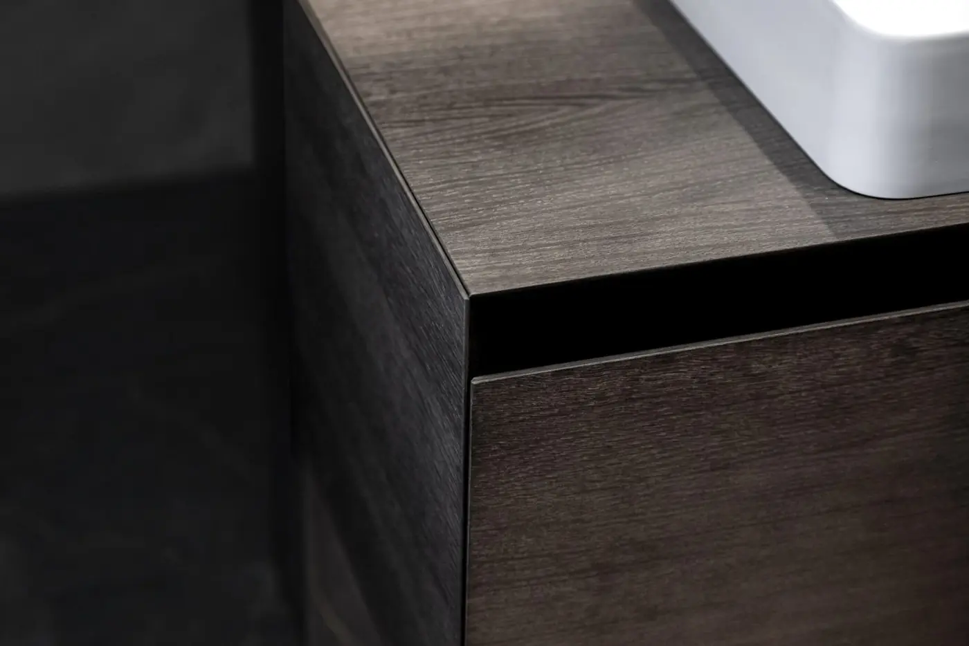 Corner detail of a dark oak kitchen front