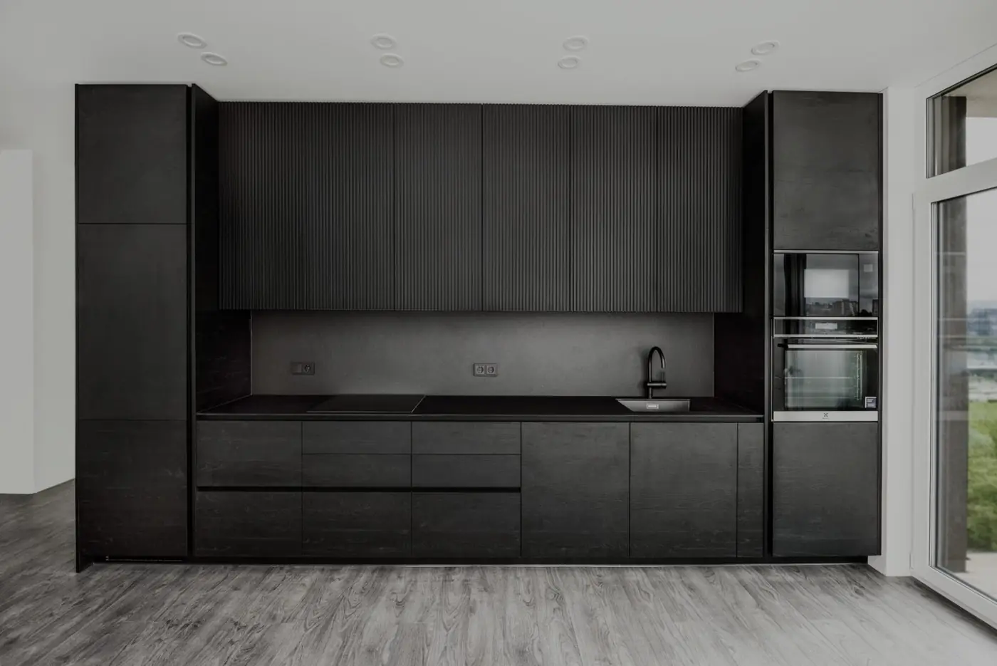 Black custom kitchen wall with tall units